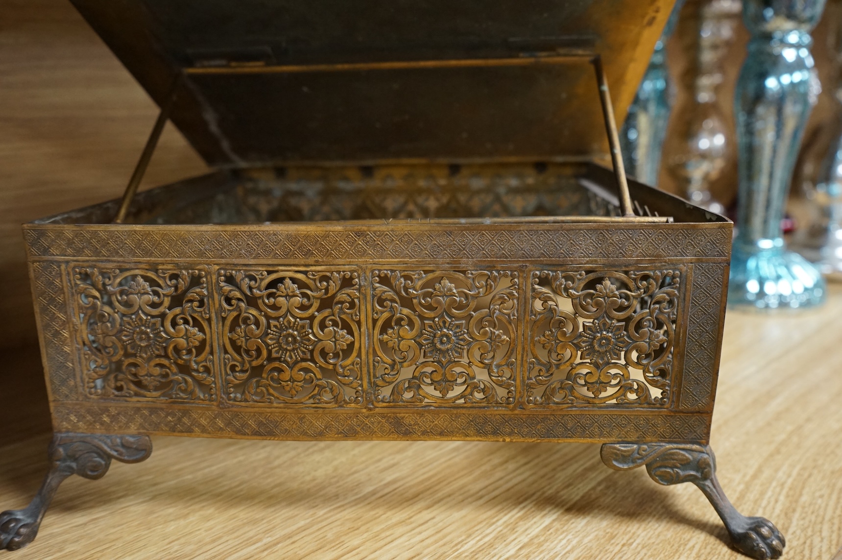 A French Limoges enamel and gilt metal lectern stand with glass cabochons and paw feet, 30cm wide